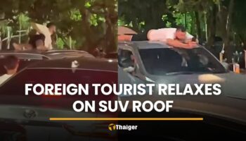 Иностранец, заметивший себя, расслабляясь на крыше внедорожника во время движения в Пхукете